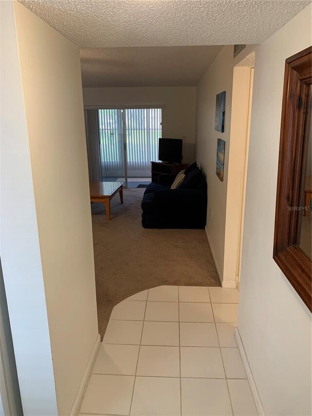 4502 3rd Street Cir W Unit 242, Bradenton, FL 34207 - corridor with a textured ceiling and carpet floors