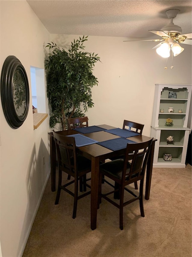 4502 3rd Street Cir W Unit 242, Bradenton, FL 34207 - dining area featuring a ceiling fan, a textured ceiling, and light colored carpet