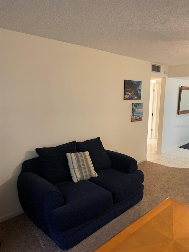 4502 3rd Street Cir W Unit 242, Bradenton, FL 34207 - living room featuring baseboards, light carpet, visible vents, and a textured ceiling