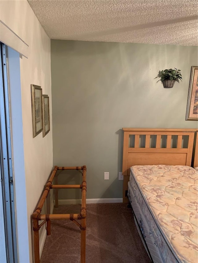 4502 3rd Street Cir W Unit 242, Bradenton, FL 34207 - bedroom with carpet, a textured ceiling, and baseboards
