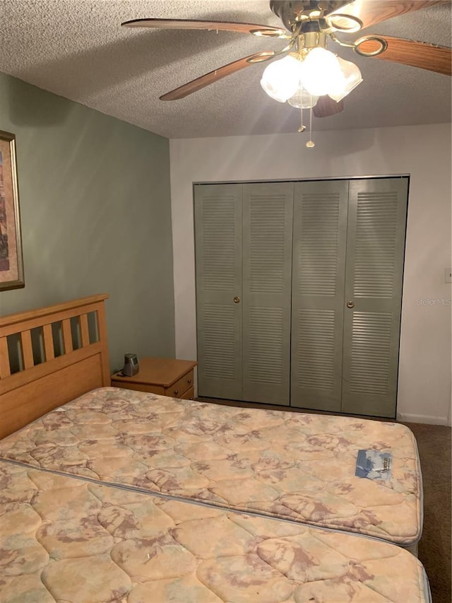 4502 3rd Street Cir W Unit 242, Bradenton, FL 34207 - bedroom featuring carpet floors, a textured ceiling, a closet, and a ceiling fan