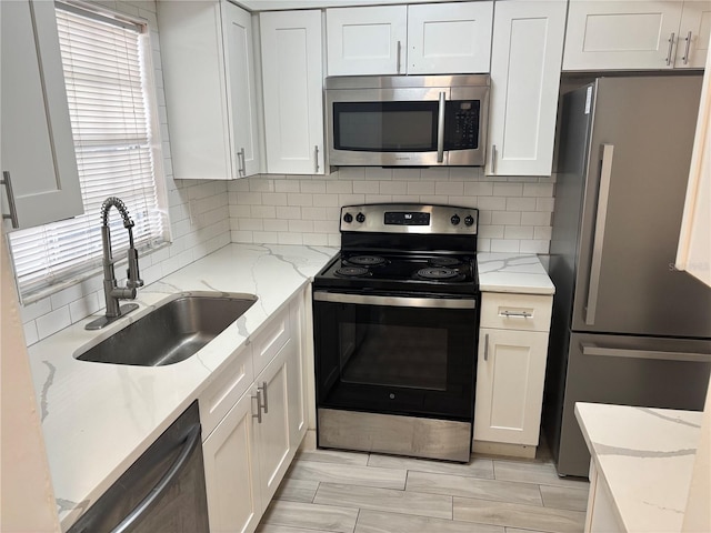kitchen featuring white cabinetry, appliances with stainless steel finishes, and a sink