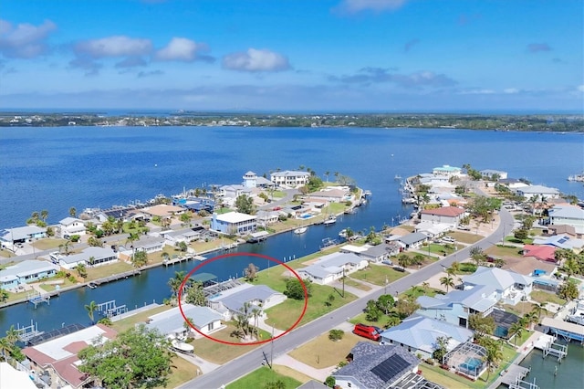 drone / aerial view with a water view and a residential view