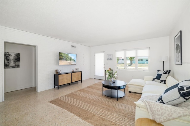 living area with visible vents and speckled floor