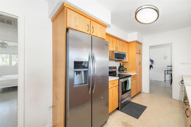 kitchen with light countertops, visible vents, light brown cabinetry, and appliances with stainless steel finishes