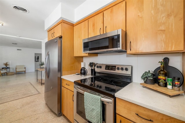 kitchen featuring light countertops, stainless steel appliances, and visible vents