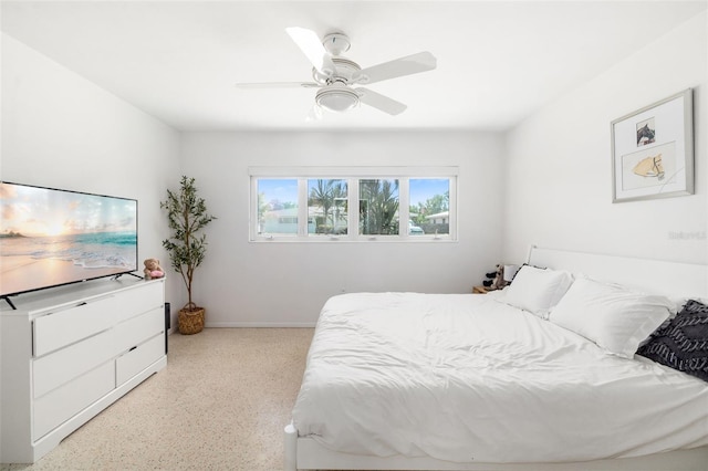 bedroom with baseboards, a ceiling fan, and speckled floor