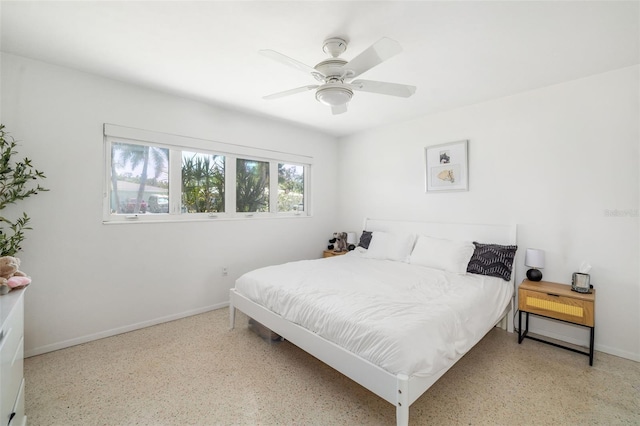 bedroom with ceiling fan, baseboards, and speckled floor