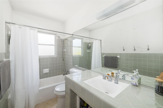 full bath featuring vanity, toilet, tile walls, and shower / bath combination with curtain