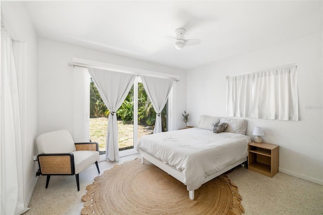 bedroom featuring baseboards and access to exterior