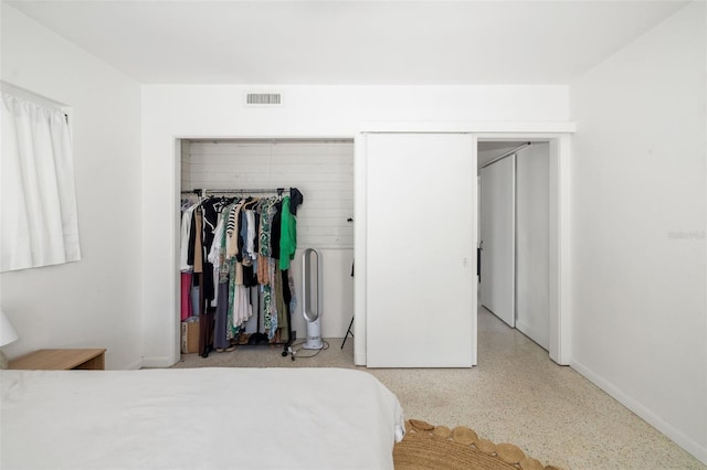 bedroom with speckled floor, baseboards, and visible vents