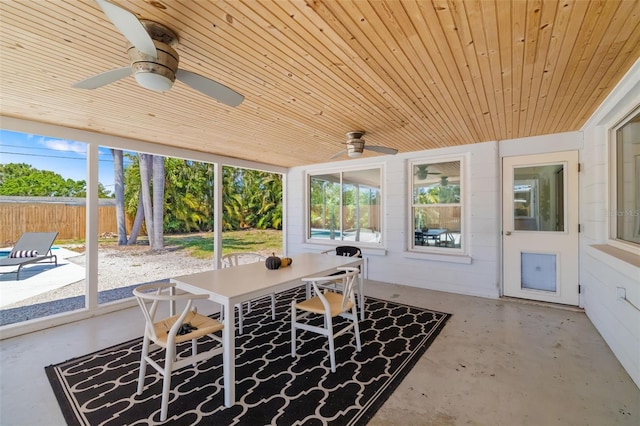 sunroom / solarium featuring ceiling fan, outdoor dining space, and plenty of natural light
