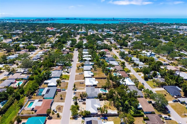 drone / aerial view with a water view and a residential view