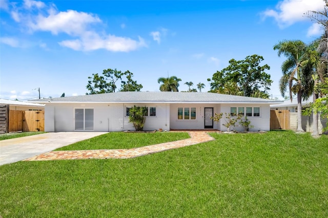 single story home featuring a front lawn, a gate, fence, and driveway
