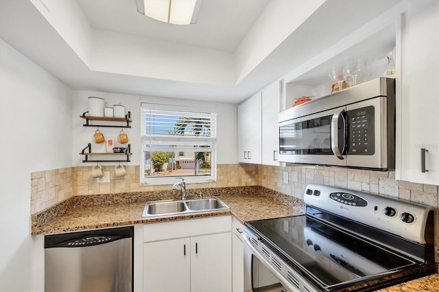 kitchen with white cabinets, appliances with stainless steel finishes, open shelves, and a sink