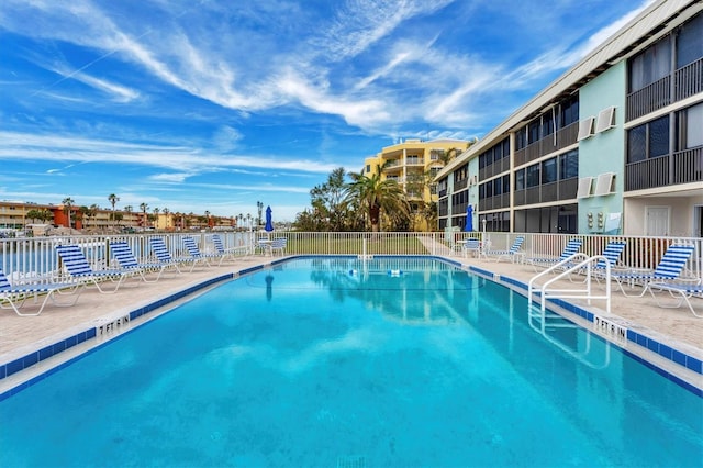 pool featuring fence and a patio
