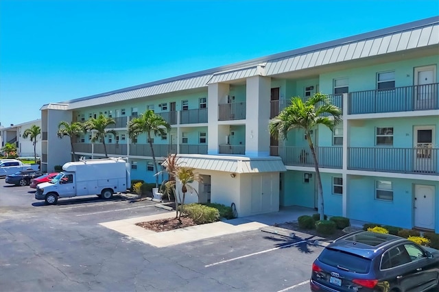 view of building exterior with uncovered parking