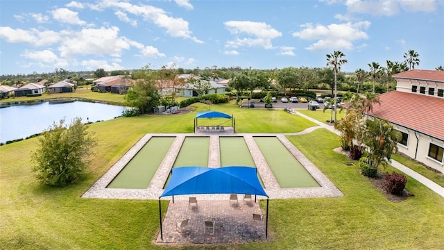 surrounding community featuring a water view, a yard, and a residential view