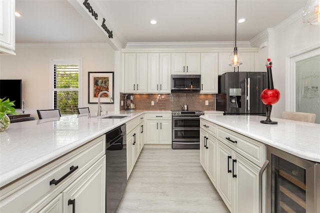 2705 Taheebo Way, North Port, FL 34289 - kitchen featuring stainless steel appliances, a sink, beverage cooler, crown molding, and tasteful backsplash