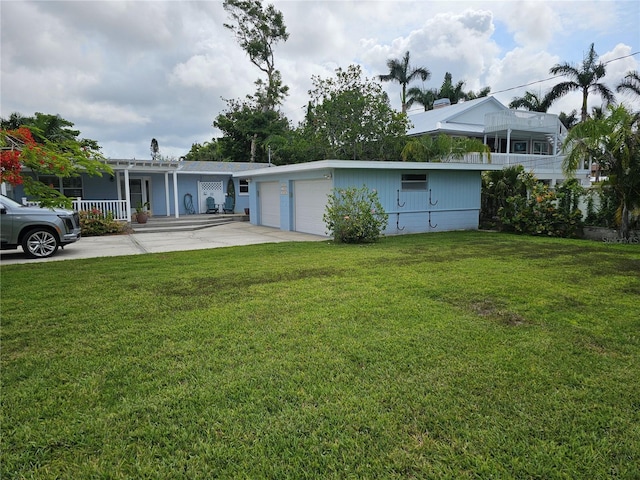 1654 Blakemore Ln, Sarasota, FL 34231 - back of house with a lawn and a garage