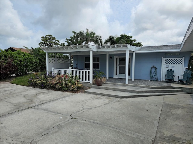 1654 Blakemore Ln, Sarasota, FL 34231 - view of front of house with a porch and a pergola