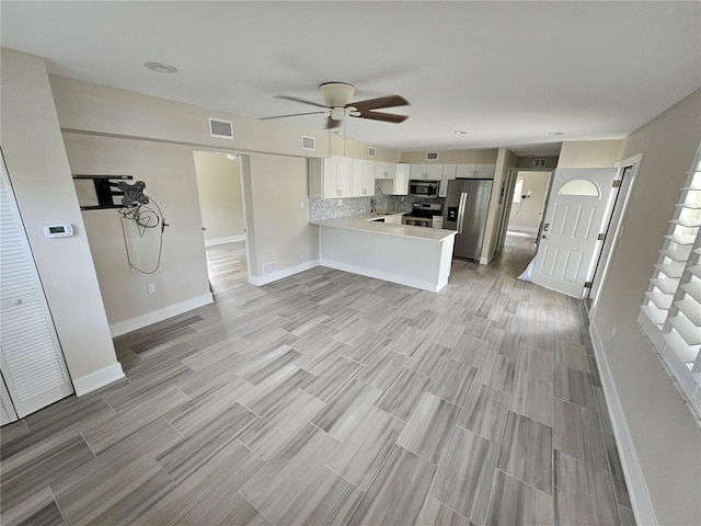 1654 Blakemore Ln, Sarasota, FL 34231 - kitchen with stainless steel appliances, light countertops, a peninsula, baseboards, and ceiling fan