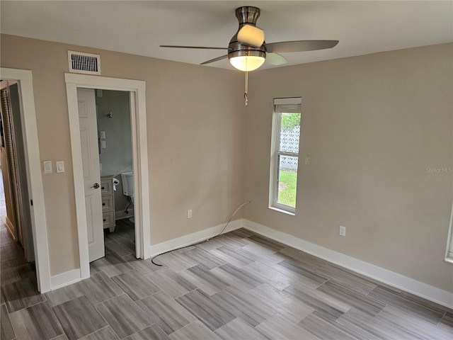 1654 Blakemore Ln, Sarasota, FL 34231 - unfurnished bedroom with baseboards, wood finish floors, and a ceiling fan