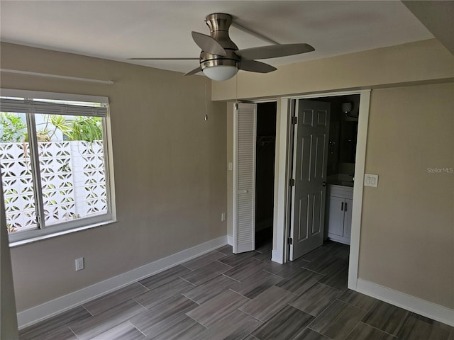1654 Blakemore Ln, Sarasota, FL 34231 - unfurnished bedroom featuring baseboards, a closet, and wood finish floors