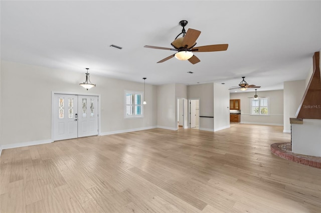 1828 Mova St, Sarasota, FL 34231 - unfurnished living room featuring a ceiling fan, light wood-type flooring, and baseboards
