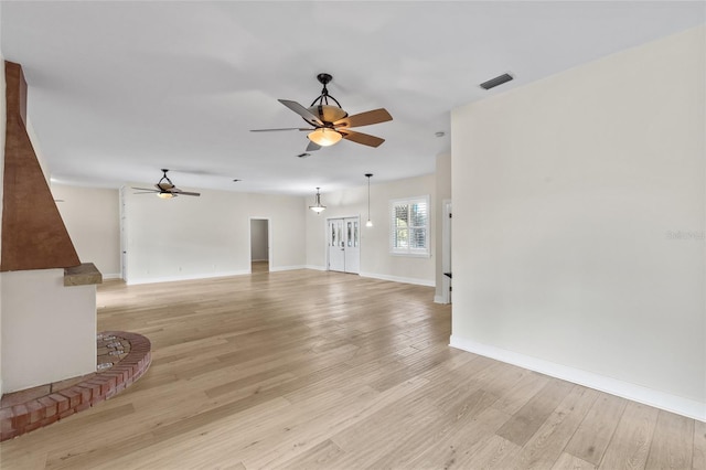 1828 Mova St, Sarasota, FL 34231 - unfurnished living room featuring a ceiling fan, light wood-type flooring, and baseboards