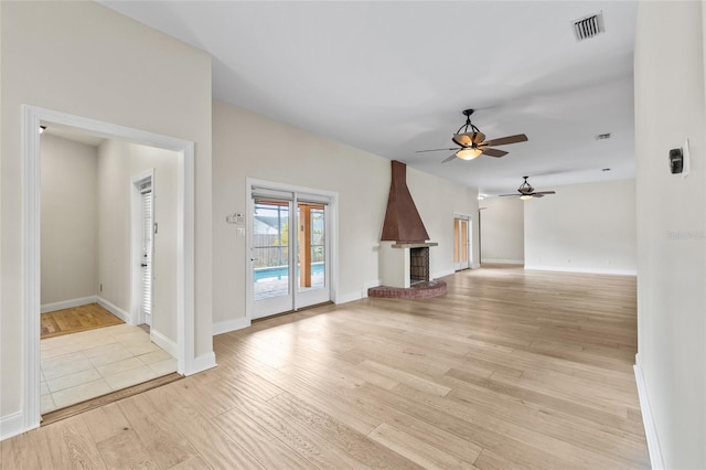1828 Mova St, Sarasota, FL 34231 - unfurnished living room featuring a ceiling fan, light wood-style flooring, baseboards, and a fireplace