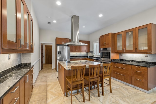 1828 Mova St, Sarasota, FL 34231 - kitchen with island exhaust hood, appliances with stainless steel finishes, a kitchen island, backsplash, and recessed lighting