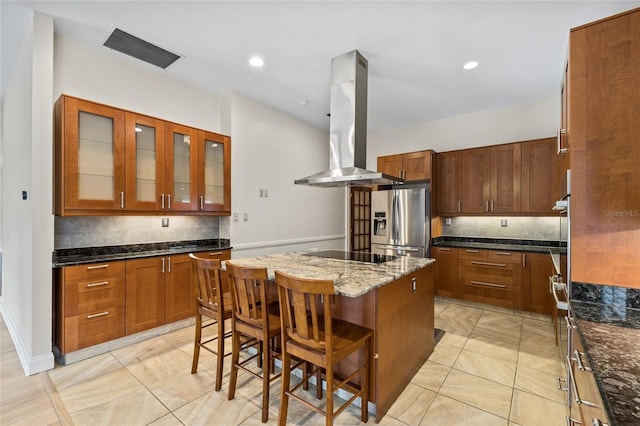 1828 Mova St, Sarasota, FL 34231 - kitchen with island range hood, stainless steel fridge, a center island, decorative backsplash, and recessed lighting