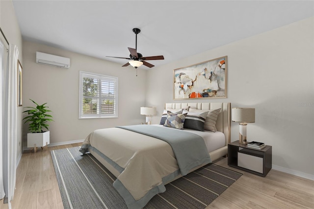 1828 Mova St, Sarasota, FL 34231 - bedroom featuring a wall mounted AC, light wood-type flooring, baseboards, and a ceiling fan