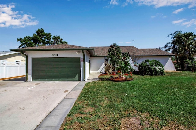 9011 Hilolo Ln, Venice, FL 34293 - ranch-style house with stucco siding, a front yard, fence, an attached garage, and driveway