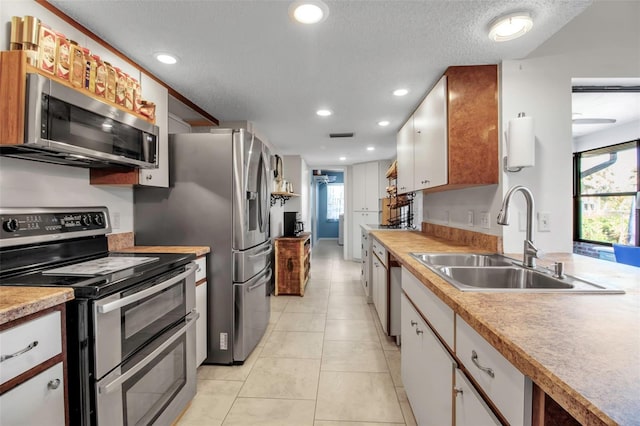 9011 Hilolo Ln, Venice, FL 34293 - kitchen featuring a sink, white cabinetry, and stainless steel appliances