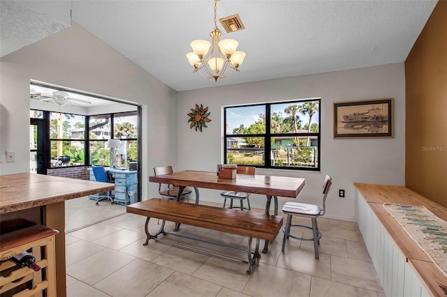 9011 Hilolo Ln, Venice, FL 34293 - dining room with vaulted ceiling, light tile patterned floors, a textured ceiling, visible vents, and ceiling fan with notable chandelier