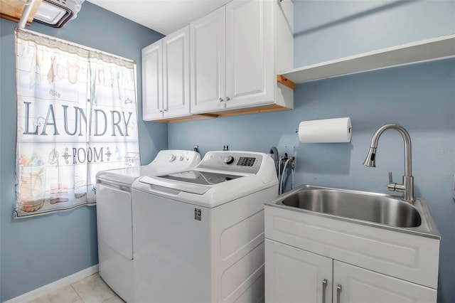 9011 Hilolo Ln, Venice, FL 34293 - laundry room featuring light tile patterned floors, baseboards, a sink, cabinet space, and washing machine and dryer