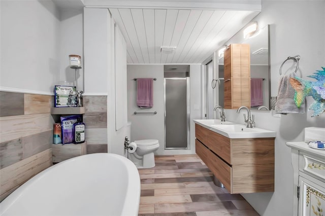 9011 Hilolo Ln, Venice, FL 34293 - full bath featuring wooden ceiling, a soaking tub, vanity, wood finished floors, and a stall shower