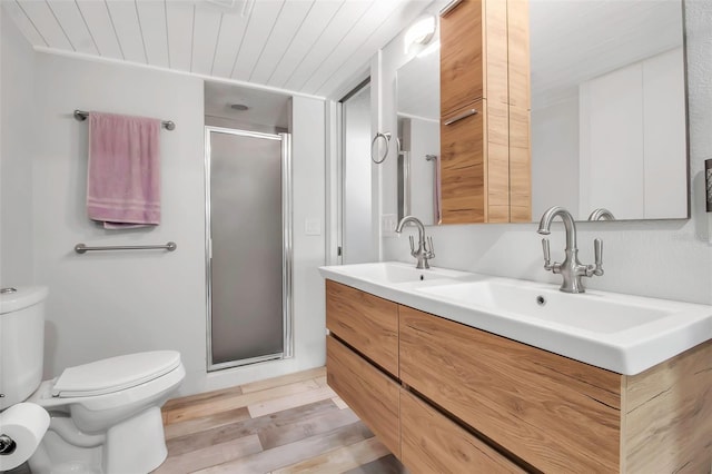 9011 Hilolo Ln, Venice, FL 34293 - bathroom with a sink, toilet, a shower stall, and double vanity