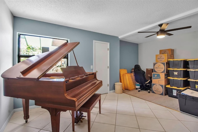 9011 Hilolo Ln, Venice, FL 34293 - living area with baseboards, tile patterned flooring, a textured ceiling, and a ceiling fan