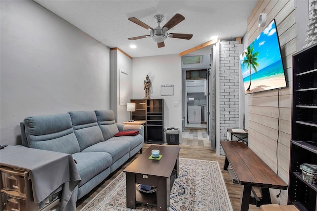 9011 Hilolo Ln, Venice, FL 34293 - living room with a textured ceiling, wood finished floors, and ceiling fan