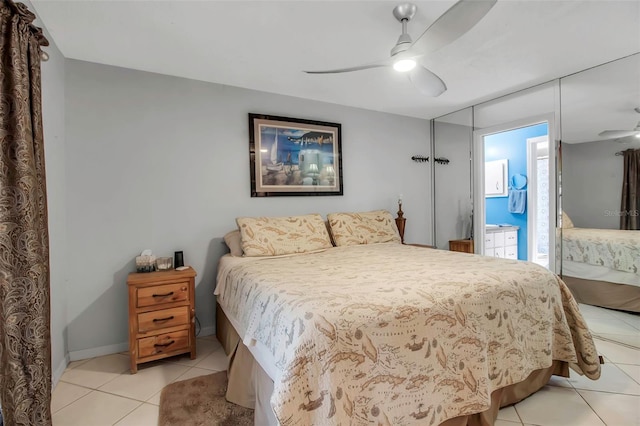 9011 Hilolo Ln, Venice, FL 34293 - bedroom with access to outside, baseboards, a ceiling fan, and light tile patterned flooring