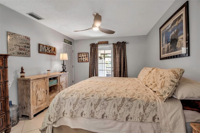 9011 Hilolo Ln, Venice, FL 34293 - bedroom with visible vents, a ceiling fan, and light tile patterned floors