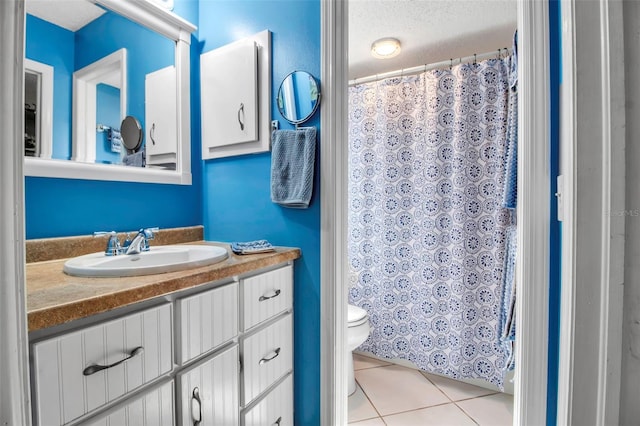 9011 Hilolo Ln, Venice, FL 34293 - bathroom featuring vanity, tile patterned floors, a textured ceiling, a shower with curtain, and toilet
