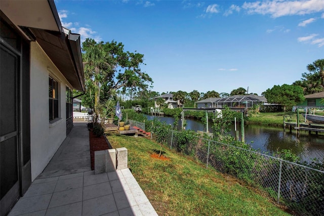 9011 Hilolo Ln, Venice, FL 34293 - view of yard with a water view, a patio area, and fence