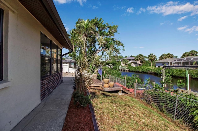 9011 Hilolo Ln, Venice, FL 34293 - view of yard with a deck with water view and fence