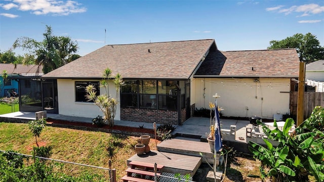 9011 Hilolo Ln, Venice, FL 34293 - view of front facade featuring a patio area, fence, a sunroom, and roof with shingles