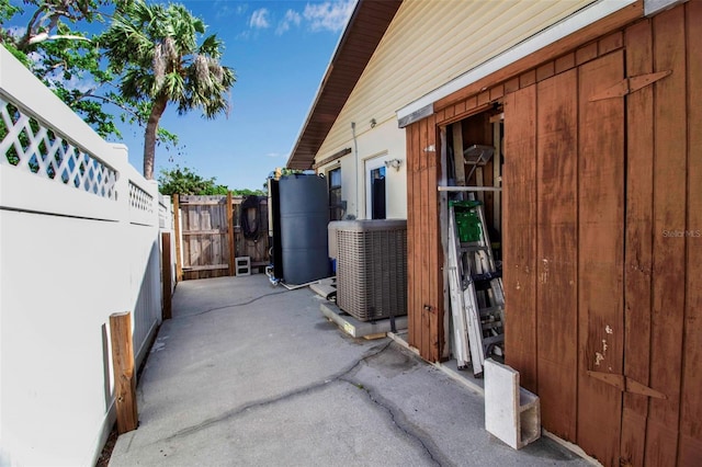 9011 Hilolo Ln, Venice, FL 34293 - view of patio featuring central AC unit and fence