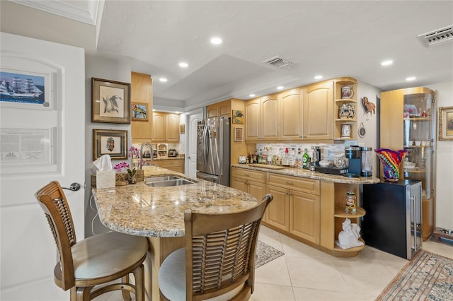 kitchen featuring a sink, visible vents, open shelves, and freestanding refrigerator